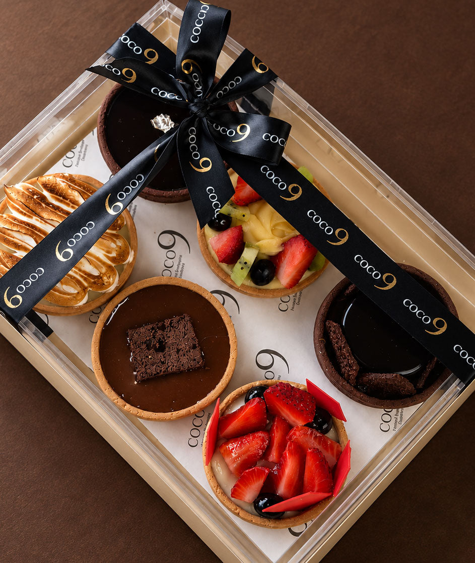 A finished box with its ribbon tied, shot from slightly above.